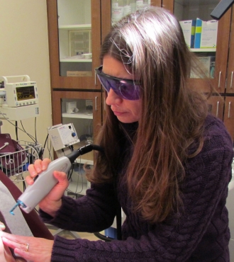 Woman performing laser treatment